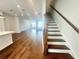 Open-concept living space featuring hardwood floors and staircase at 518 Healy Dr # 68, Cumming, GA 30040