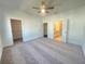 Spacious main bedroom with carpeted floor, ceiling fan, and bathroom access at 518 Healy Dr # 68, Cumming, GA 30040