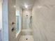 Shower showcasing marble tile and a built-in bench at 518 Healy Dr # 68, Cumming, GA 30040
