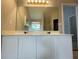 Primary bathroom featuring double vanity, large mirror and ample storage at 690 Kimball Parc Way, Alpharetta, GA 30022