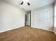 Cozy bedroom with neutral walls, carpeted floors, and closet storage space at 690 Kimball Parc Way, Alpharetta, GA 30022