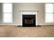 Cozy living room featuring a classic white fireplace and large windows at 690 Kimball Parc Way, Alpharetta, GA 30022