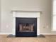 Living room with a classic white fireplace and windows with blinds for natural lighting at 690 Kimball Parc Way, Alpharetta, GA 30022