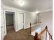 Upstairs hallway featuring neutral walls, carpeted floors, and natural lighting at 690 Kimball Parc Way, Alpharetta, GA 30022
