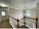 Hallway with wooden banister overlooking the front door and foyer at 690 Kimball Parc Way, Alpharetta, GA 30022