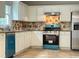 Well-lit kitchen with white cabinets, stainless steel appliances, and granite countertops at 690 Kimball Parc Way, Alpharetta, GA 30022