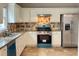 Well-lit kitchen with white cabinets, stainless steel appliances, and granite countertops at 690 Kimball Parc Way, Alpharetta, GA 30022