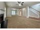 Open-concept living space with fireplace, ceiling fan, and staircase in the background at 690 Kimball Parc Way, Alpharetta, GA 30022