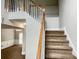 Carpeted staircase featuring a wooden handrail, leading to the upper level of the home at 690 Kimball Parc Way, Alpharetta, GA 30022