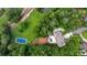 An aerial image of a luxury home on private wooded acreage with a tennis court and a pool at 1430 N Harris Rdg, Atlanta, GA 30327