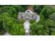 Aerial view of a luxury home with a pool, tennis court, and circular driveway, surrounded by lush trees at 1430 N Harris Rdg, Atlanta, GA 30327