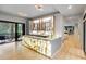 Entertainer's bar with an illuminated onyx countertop and decorative shelving, with seamless indoor outdoor flow at 1430 N Harris Rdg, Atlanta, GA 30327