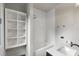 Bathroom features a shower with white subway tile, and built-in shelving at 1430 N Harris Rdg, Atlanta, GA 30327