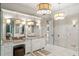 Elegant bathroom with marble floors, custom cabinets and stylish lighting fixtures at 1430 N Harris Rdg, Atlanta, GA 30327