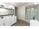 Modern bathroom featuring a double sink vanity, glass shower and sleek fixtures at 1430 N Harris Rdg, Atlanta, GA 30327