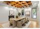 Formal dining room with coffered ceiling, contemporary chandelier, modern art and fireplace at 1430 N Harris Rdg, Atlanta, GA 30327