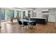 Bright dining room with a glass dining table, modern chairs, and a view of the exterior foliage through large windows at 1430 N Harris Rdg, Atlanta, GA 30327