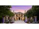 Elegant two-story home showcasing a gated entrance, lush greenery, and beautiful sunset sky at 1430 N Harris Rdg, Atlanta, GA 30327
