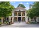 Elegant home featuring a gated entrance, stone facade, and a two-story porch at 1430 N Harris Rdg, Atlanta, GA 30327