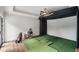 Home golf simulator room with artificial turf, a projector screen, and golf equipment for indoor practice at 1430 N Harris Rdg, Atlanta, GA 30327