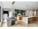 Gourmet kitchen featuring stainless steel appliances, a large island, and an adjacent breakfast nook with a modern chandelier at 1430 N Harris Rdg, Atlanta, GA 30327