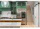 Beautiful kitchen showcasing green cabinetry, a large island with marble countertop, and premium appliances at 1430 N Harris Rdg, Atlanta, GA 30327