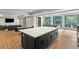 Spacious open floor plan with a large kitchen island, dining area, sitting area and view of trees outside large picture windows at 1430 N Harris Rdg, Atlanta, GA 30327