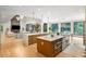 Open-concept kitchen featuring a large island with seating and stainless steel appliances and modern lighting at 1430 N Harris Rdg, Atlanta, GA 30327