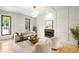Bright living room features a fireplace, modern decor, large windows, and an open layout for comfortable entertaining at 1430 N Harris Rdg, Atlanta, GA 30327
