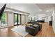 Open-concept living room with hardwood floors, walkout and adjacent kitchen at 1430 N Harris Rdg, Atlanta, GA 30327