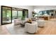 Spacious living room showcasing floor-to-ceiling windows, stylish furnishings, and open layout to the kitchen at 1430 N Harris Rdg, Atlanta, GA 30327