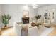 Elegant living room featuring a fireplace, decorative molding, stylish furniture, and abundant natural light at 1430 N Harris Rdg, Atlanta, GA 30327