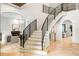 Elegant staircase featuring sleek black railings, light wood steps, and stylish architectural design at 1430 N Harris Rdg, Atlanta, GA 30327