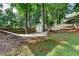 Spacious backyard featuring a hammock, shed, and ample greenery for relaxing and outdoor activities at 2633 Hanriva Ct, Dacula, GA 30019