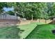 Grassy backyard with tiered beds and wooden privacy fence at 2633 Hanriva Ct, Dacula, GA 30019