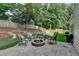 Cozy backyard patio with a stone fire pit, perfect for outdoor entertaining and relaxation at 2633 Hanriva Ct, Dacula, GA 30019