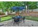Backyard patio area with a round table and umbrella, perfect for outdoor dining and relaxation at 2633 Hanriva Ct, Dacula, GA 30019
