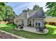 Spacious backyard with stone patio and seating areas, surrounded by lush landscaping at 2633 Hanriva Ct, Dacula, GA 30019