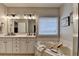 Neutral-toned bathroom with white cabinets, soaking tub, and vanity with double sinks at 2633 Hanriva Ct, Dacula, GA 30019