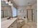 Bright bathroom featuring a soaking tub, glass shower, and white vanity with double sinks at 2633 Hanriva Ct, Dacula, GA 30019