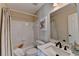 Well-lit bathroom with a white vanity, a bathtub, and an elephant picture on the wall at 2633 Hanriva Ct, Dacula, GA 30019