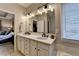 Relaxing bathroom featuring a soaking tub, glass shower, and vanity with double sinks at 2633 Hanriva Ct, Dacula, GA 30019