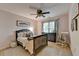 Cozy bedroom features a ceiling fan, decorative pillows, and comfortable rocking chair at 2633 Hanriva Ct, Dacula, GA 30019