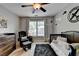 Bedroom with a ceiling fan, airplane-themed wall art, and a window with natural light at 2633 Hanriva Ct, Dacula, GA 30019