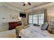 Beautiful bedroom with tray ceilings, decorative artwork, large window, and dark wood furnishings at 2633 Hanriva Ct, Dacula, GA 30019