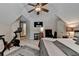 Comfortable bedroom features a ceiling fan, television, peloton, and an adjacent sitting area at 2633 Hanriva Ct, Dacula, GA 30019