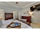 Lovely bedroom with tray ceilings, decorative artwork, and dark wood furnishings at 2633 Hanriva Ct, Dacula, GA 30019