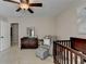 Bedroom with crib, chair, ottoman, dresser, mirror, and soft carpet at 2633 Hanriva Ct, Dacula, GA 30019