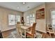 A sunny dining area is set up for four and features backyard access and an art accent wall at 2633 Hanriva Ct, Dacula, GA 30019