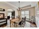 Charming dining room featuring hardwood floors, a modern chandelier, and a view of the home office at 2633 Hanriva Ct, Dacula, GA 30019